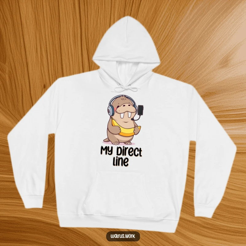 Funny hoodie featuring a giggling walrus with a headset, mistakenly using a banana as a phone, offering cozy comfort and humor.
